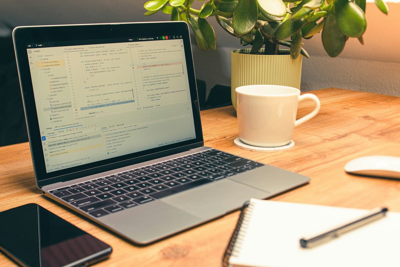 A laptop open to a working build on a wooden desk, coffee beside it — the first agent is smaller than you think