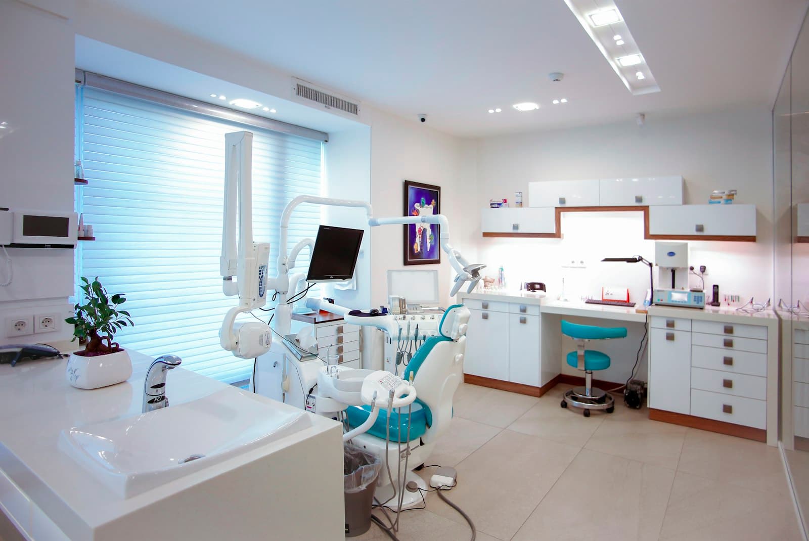 A bright, modern dental operatory with the chair ready for the next patient